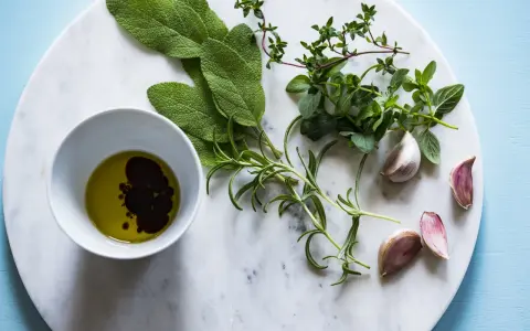 Świeże zioła: szałwia, tymianek, rozmaryn, czosnek i oliwa z oliwek z octem balsamicznym. Naturalne sposoby na wsparcie gospodarki wodnej organizmu.